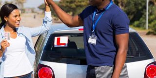 unnamed 32518012 - happy african girl and driving instructor doing high five after getting her driving license